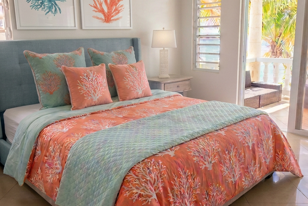 Master suite with coral and aqua bedding opening to a sea-view balcony